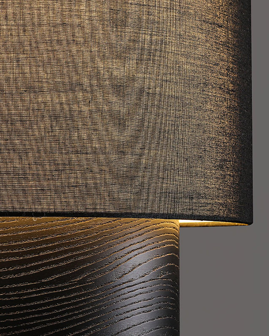 Close view of the cloth shade weave and the brushed wood plinth