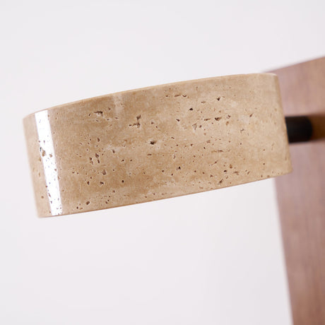 The porous travertine drum seen close where it meets the wood bar