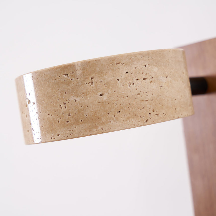 The porous travertine drum seen close where it meets the wood bar