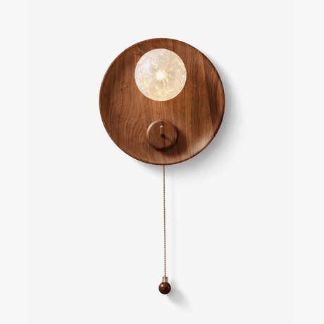 Wall lamp for reading, a walnut disc with a textured globe and a pull chain