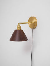 Side view of the brass arm carrying the walnut cone shade
