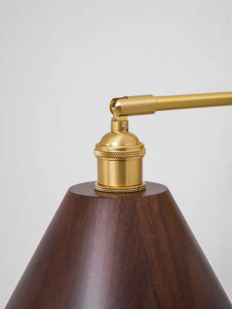 Detail of the brass arm and socket above the turned walnut shade