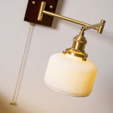 Close view of the brass joint where the arm meets the ceramic shade