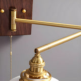Close view of the brass elbow and the pull chain hanging beside it
