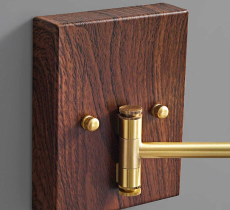 Walnut wall plate with two brass fittings and the arm leaving the plate