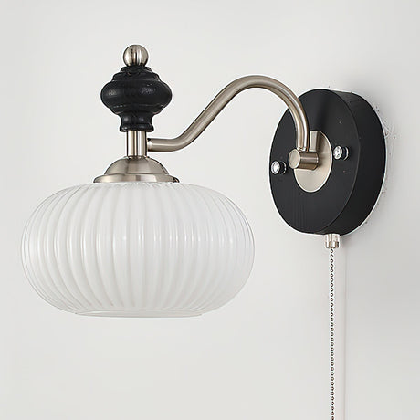 A fluted white glass shade seen from the front on the nickel arm