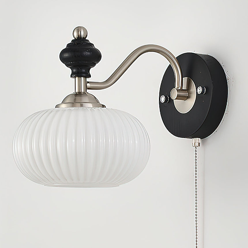 A fluted white glass shade seen from the front on the nickel arm