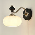 The ribbed white glass dome on its nickel arm and black wood plate