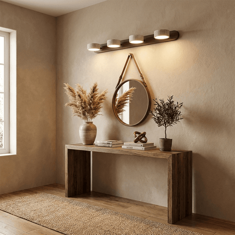 Lit above a console table in a hallway with a round mirror and dried grasses