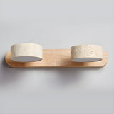 The light wood bar with two travertine shades, switched off against pale gray