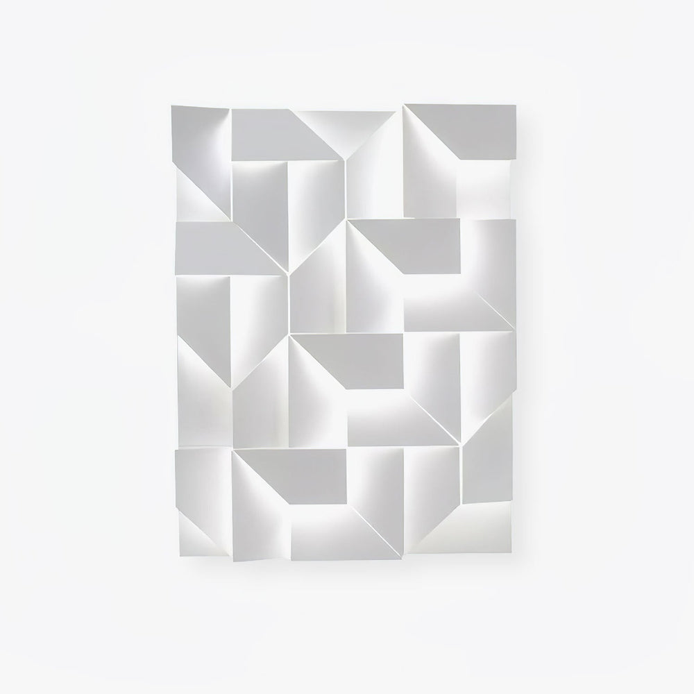 A large white panel of folded facets, the fitting switched off on a plain wall