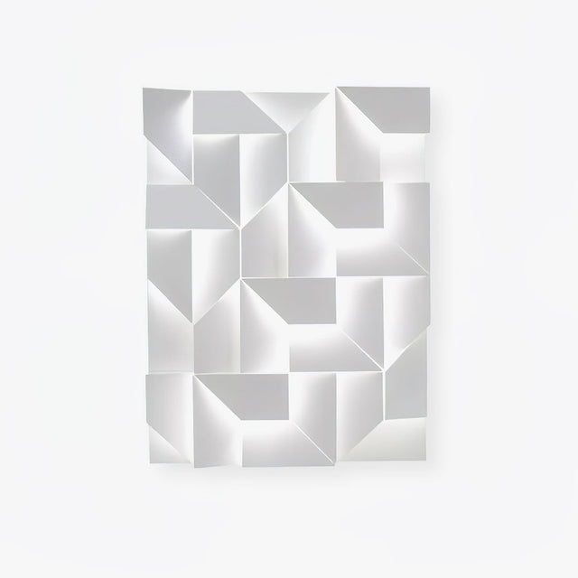 A large white panel of folded facets, the fitting switched off on a plain wall