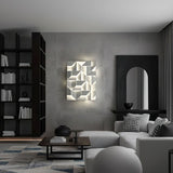 Lit in a living room above a pale sofa beside tall shelves and a dark arch