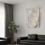 Lit on a pale wall beside a tall plant, a dark sofa and a long curtain