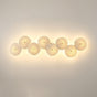 Eight discs in a horizontal row, each glowing warm on a beige wall
