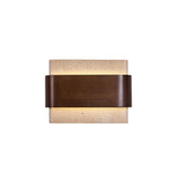 The travertine block seen from the front with the walnut band across it