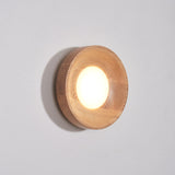 Light wood drum lit warm, the white disc set inside the straight sided rim