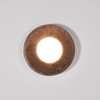 Walnut drum lit warm, the white disc recessed inside the straight rim