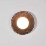 Walnut drum lit warm, the white disc recessed inside the straight rim