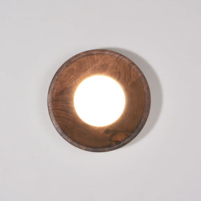 Walnut drum lit warm, the white disc recessed inside the straight rim
