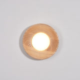 Light wood drum lit and seen at an angle, the beam grazing the wall