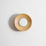 Light wood drum seen at an angle, the grain running around the straight rim