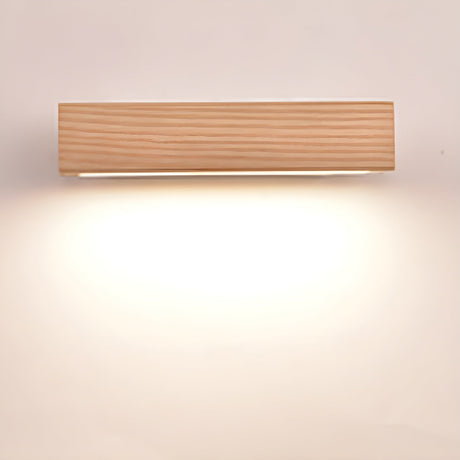 The wood bar lit level on its bracket, a broad wash falling down the wall