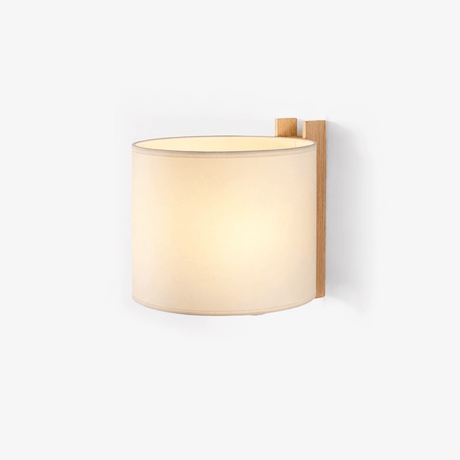 Wall sconce with a curved beige fabric shade wrapped around a wood post