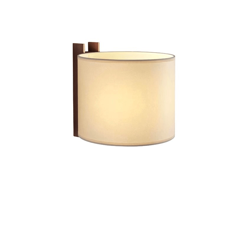 The wide beige shade curved around its wood post, seen unlit at an angle