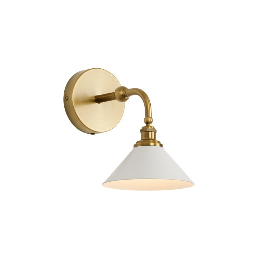The single brass sconce seen from the side, showing the curved arm and round plate