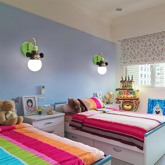 Two animal lamps lit above children's beds in a shared bedroom with striped covers