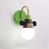 The green monkey lamp lit, its brown face with big ears and a green plate