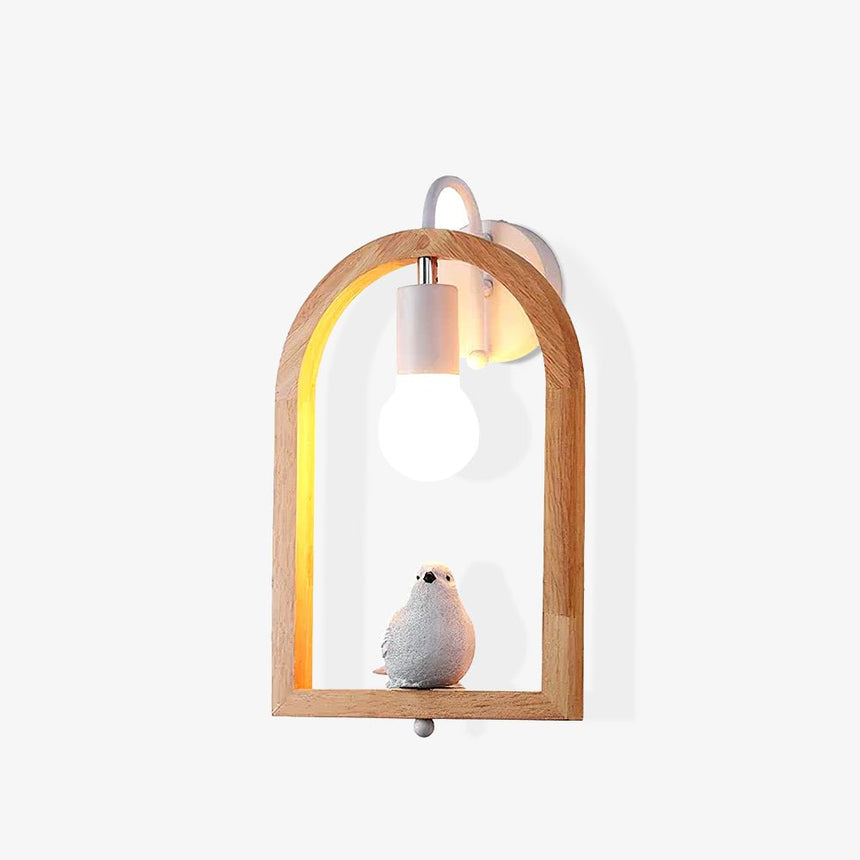 The bird model lit square on, the oak arch framing the glowing globe