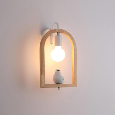 The bird model lit on a pale wall, the globe glowing inside the arch