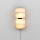 The two block lamp lit, the veins of the alabaster showing through the glow