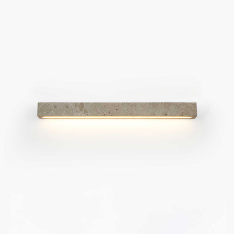 Solid travertine bar on a wall, a warm slot of light running along its lower edge