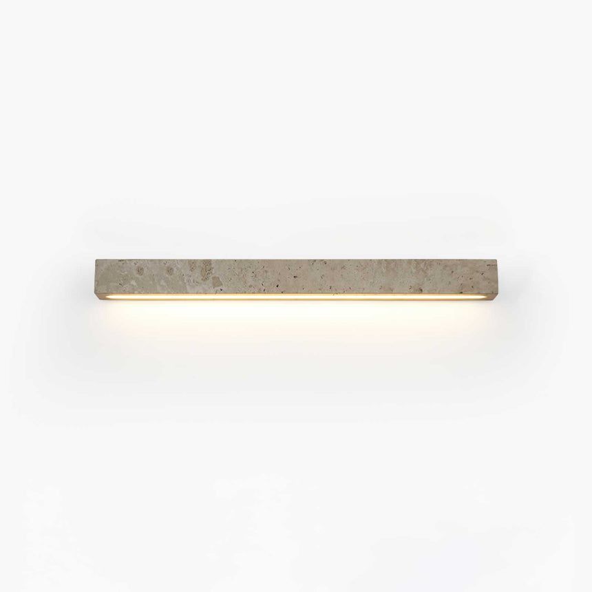 Solid travertine bar on a wall, a warm slot of light running along its lower edge