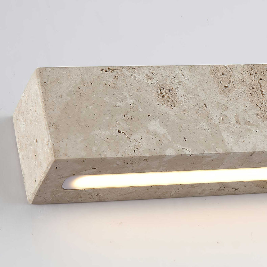Close view of the light slot cut along the underside of the travertine block