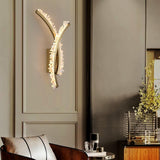 The crossed arms on a paneled wall above a leather chair and a vase of flowers
