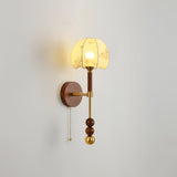 Cut amber glass shade lit, the pattern of the glass showing in the light