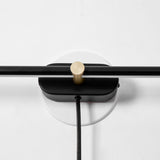 Close view of the round hub where the rod crosses the plate and the cord leaves it