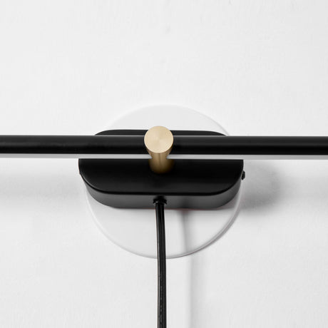 Close view of the round hub where the rod crosses the plate and the cord leaves it