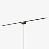 A slim dark rod on a small round plate with the cord dropping straight down