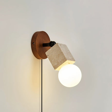 The barrel carrying a lit globe lamp, the walnut disc flat behind it
