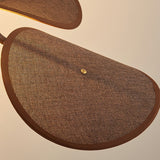 Close view of one woven fabric petal and the brass stud holding it
