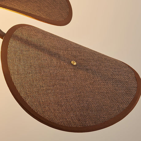 Close view of one woven fabric petal and the brass stud holding it