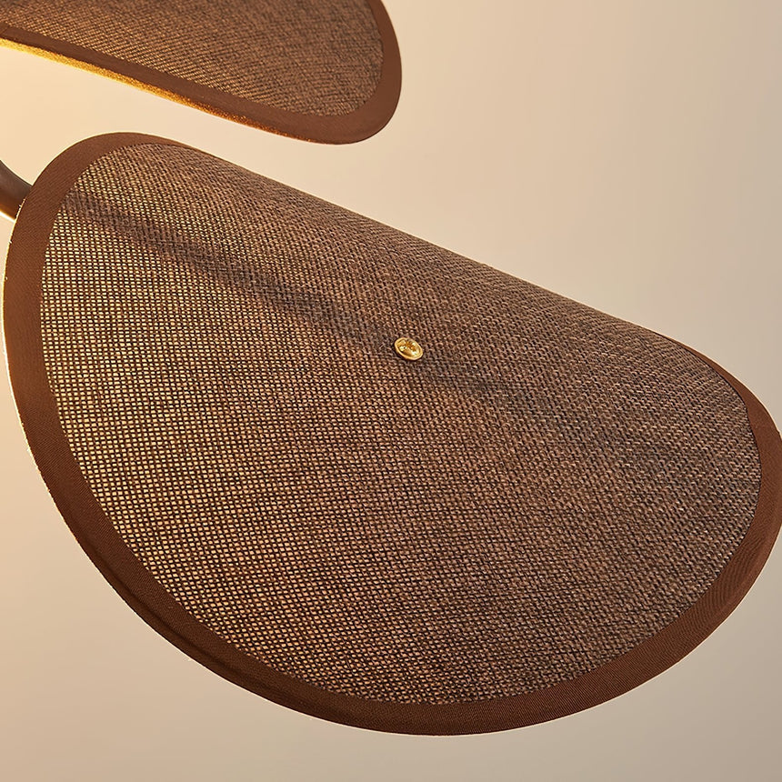 Close view of one woven fabric petal and the brass stud holding it