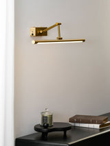 The long reach version lit above a black chest of drawers beside a pale curtain
