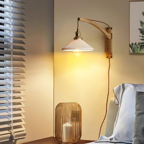 The curved arm version lit beside a window with open blinds