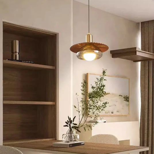 The walnut grain disc lit in a kitchen corner beside a wooden cabinet